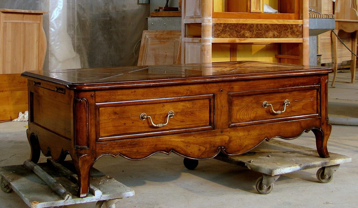 an old solid wood coffee table in the style of the Regency era