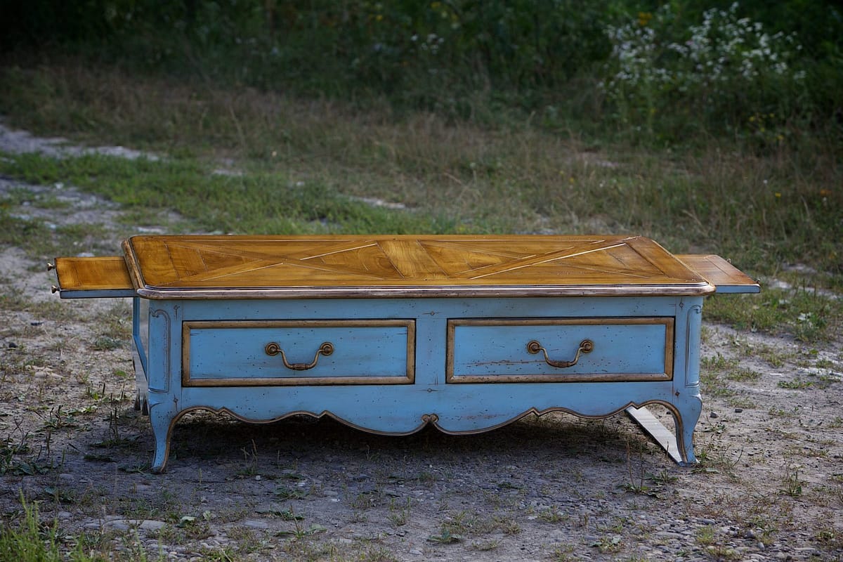 an old solid wood coffee table in the style of the Regency era